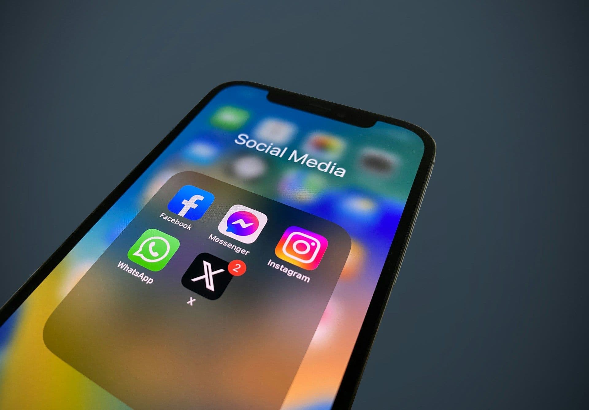 X and other social media apps on smartphone (Julian/Unsplash/Modified by CoinDesk)